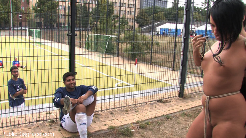 Euro babe gets tied up and exposed to a field of soccer players totally naked!!!