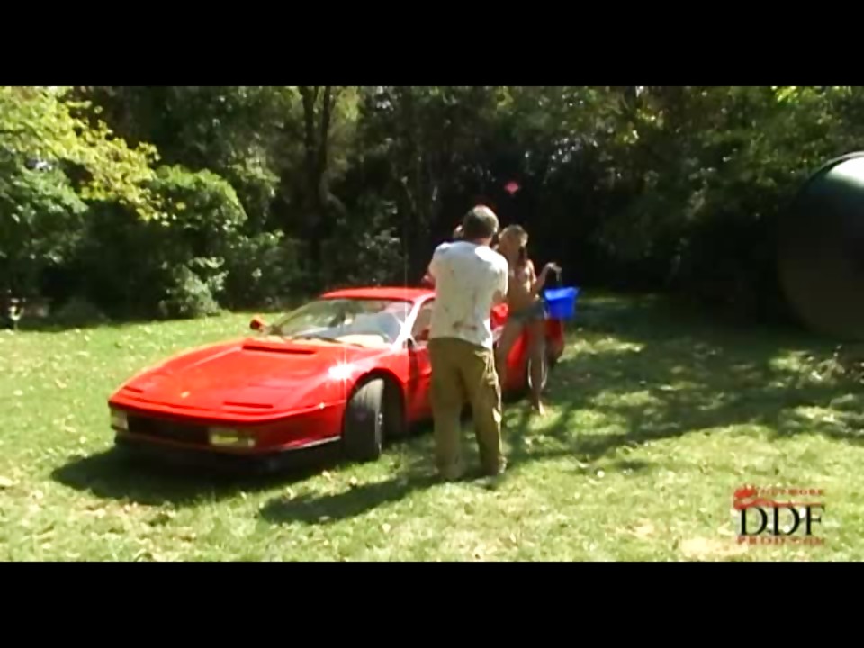 Blonde cutie washing a Ferrari